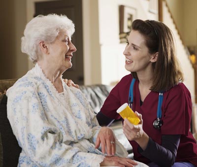 Our Nurse with client discussing medication.